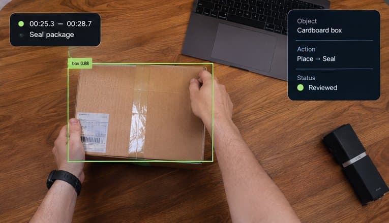 Overhead first-person view of two hands sealing a cardboard box on a desk, with the box marked by a labelled bounding box and the action Place, Seal.