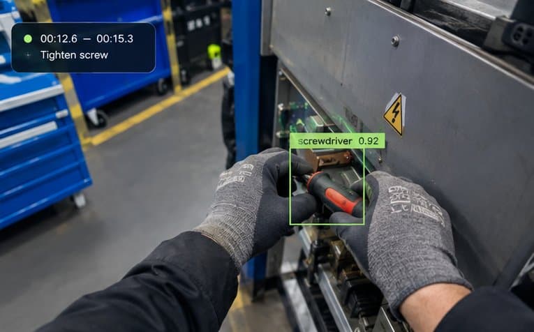 First-person view of gloved hands tightening a screw on an industrial machine panel, with the tool marked by a labelled bounding box — the kind of real-world capture task a partner team executes.